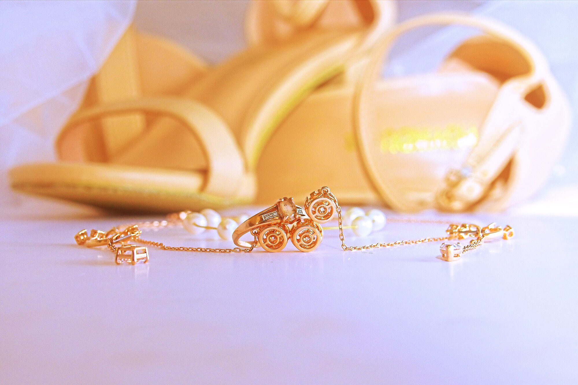 Bridal shoes and jewellery are arranged together.