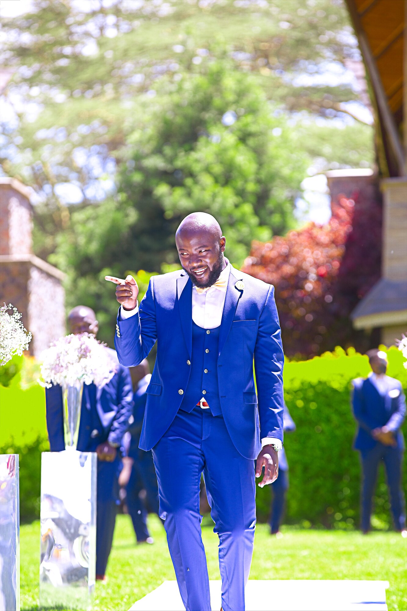 A groom walks down the aisle after the ceremony.