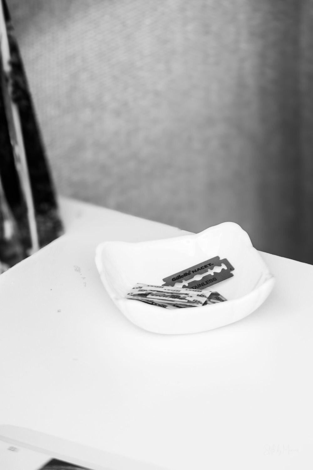 A bowl containing individually wrapped razor blades.