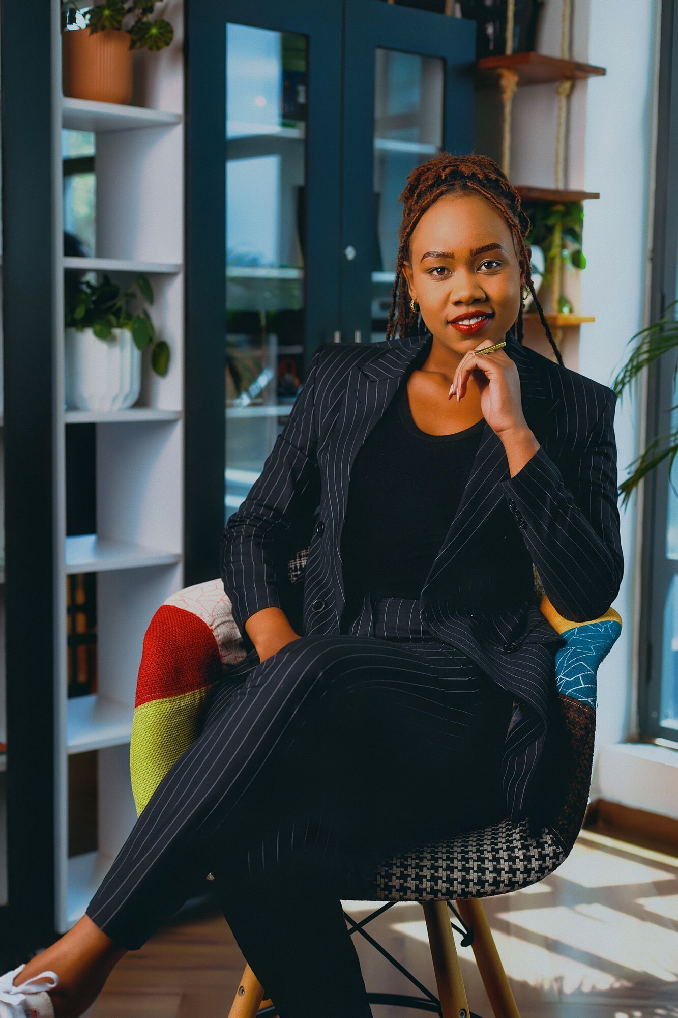 A woman stands for a personal branding portrait outdoors.